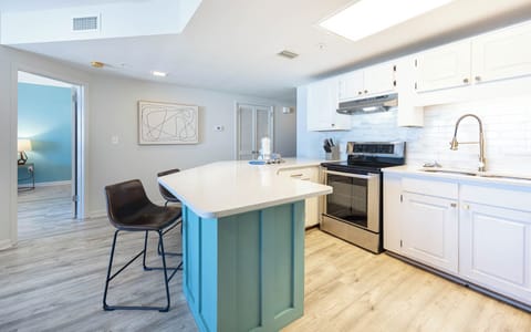 Enjoy cooking in the sleek kitchen with a spacious bar, stainless appliances, and stylish cabinetry