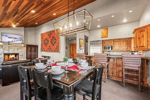 Dining Area: A spacious dining room with a wooden table that seats six, perfect for family meals or gatherings. Pendant lights hang above, casting a cozy glow.