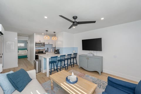 Open-concept living space with the kitchen just beside the cozy living room, creating a seamless flow for both cooking and relaxation.