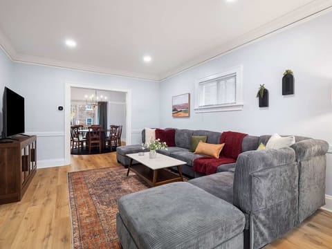 Sink into luxury—our spacious living room features a plush sofa and a sleek TV for your ultimate relaxation