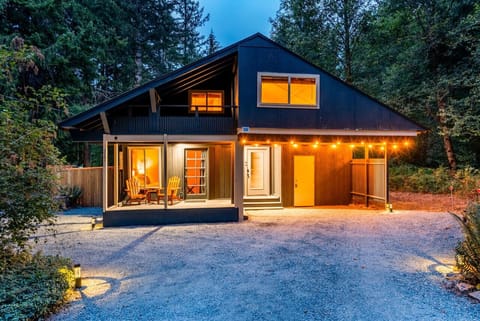 Front view of cabin, driveway solar lights & rope light accents.