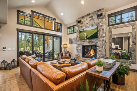 Great room — stone gas fireplace and leather sofas for group gatherings