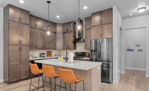 Kitchen island with three additional stools, providing extra seating and a convenient space for casual dining or socializing while cooking.