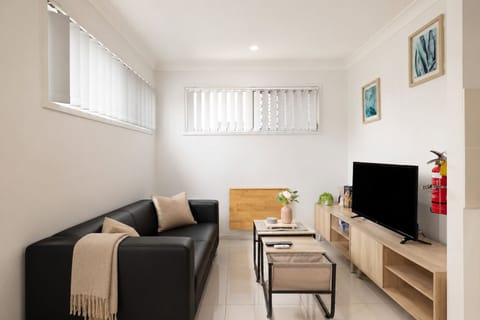 Living Area: Bright living space with comfortable seating and TV 
