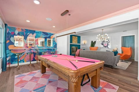 Mid-century modern game room with retro pink pool table, vintage pop-art walls, Sputnik chandelier and groovy lounge seating, Vivid Vintage Orlando