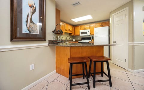 Gather around the breakfast bar with two stools, perfect for casual meals in this inviting kitchen space