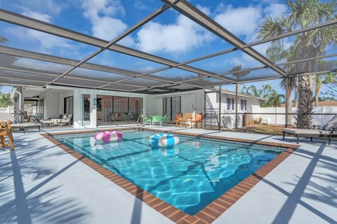 Relax and enjoy the heated pool year around! Huge Screened in patio!