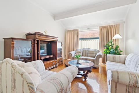 Cozy and refined lounge with timber accents and garden views.