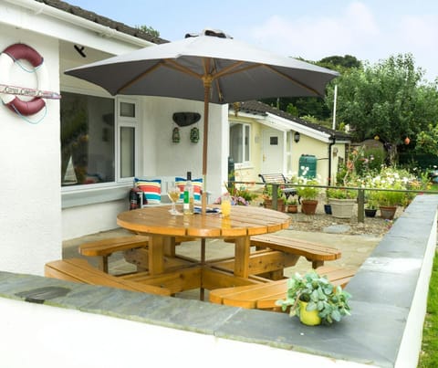 Patio with picnic table, parasol and bench