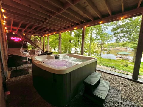 Relax and unwind in the private hot tub overlooking serene Lake Norman.