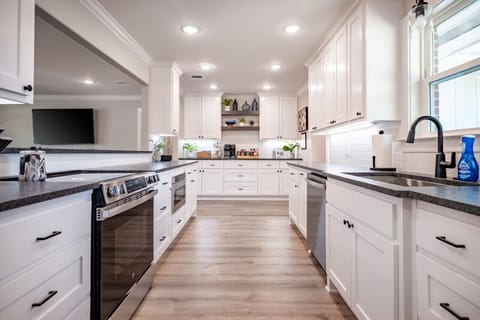 Bright, fully stocked kitchen with stainless steel appliances and farmhouse touches.