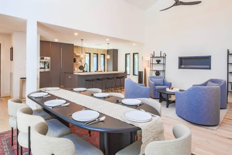 The dining table seats 8. There are 4 additional stools at the kitchen island.