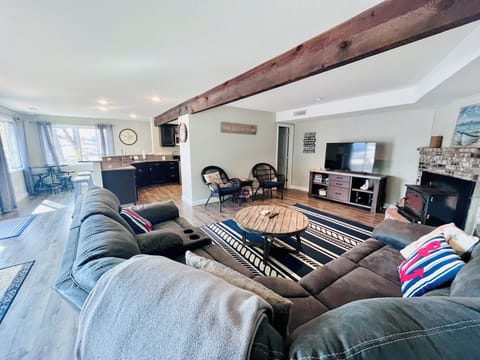 Open living room into kitchen with windows overlooking the lake!