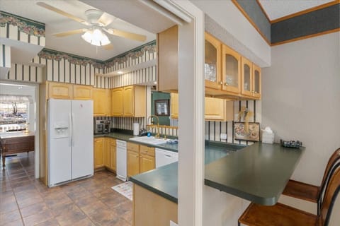 Grab a cup of coffee and have a conversation with those in the kitchen at the counter-height pass through window, with seating for two.