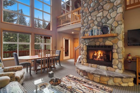 The open layout features a welcoming living room, a stylish dining room, and a gorgeous firepit that adds warmth and charm.