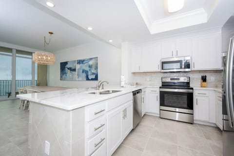 Prepare meals in this kitchen with elegant cabinetry, stainless appliances, and spacious countertops