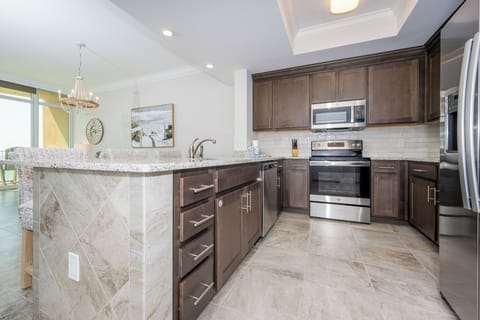 Prepare meals in this kitchen with elegant cabinetry, stainless appliances, and spacious countertops