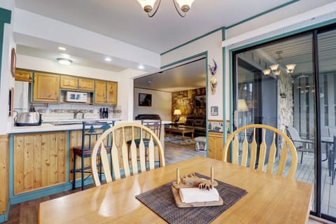 Dining room table with large windows and access out to private patio.