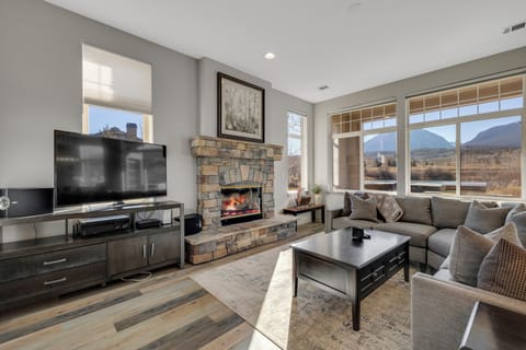 Cozy Living Room with Fireplace, TV, and tons of natural light