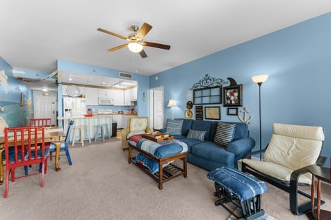 Cozy living room with blue walls and an open kitchen layout