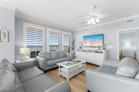 Relax in this modern living room with ocean views through large windows.