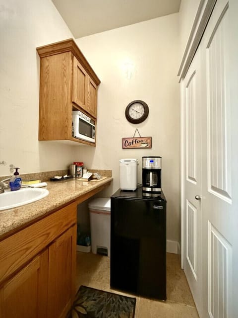 Kitchenette stocked with the essentials:  sink, microwave, refrigerator and coffee maker