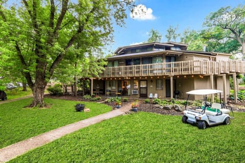 Front of condo w golf cart and fire-pit