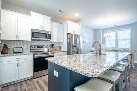 Cook and gather in this bright kitchen with a spacious island and cozy bar seating