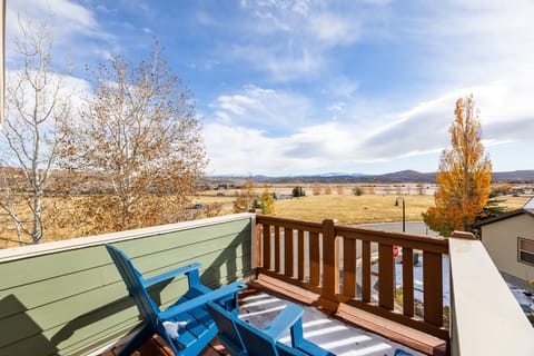 - Balcony with chairs overlooking open fields and mountain views  
- Perfect spot for morning coffee or evening sunsets  
- Relax with nature views just outside your rental