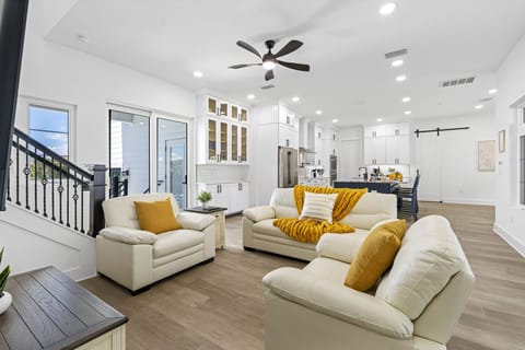 The main living room is a hub for gathering, featuring stylish furnishings, cozy seating, and a large flat-screen TV for entertainment.