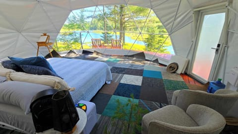The Dome Living Area - Has Watercooler, Sink with running water and seating area inside.  Out front is deck seating area overooking the Pond.  Binoculars incuded.  Super Peaceful