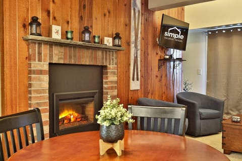 Interior of the Alpine Oasis Studio, with a smart TV to kick back with your favorite shows, and a fireplace to relax after a day on the slopes.