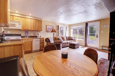 Kitchen area features a dining table with seating for 4.