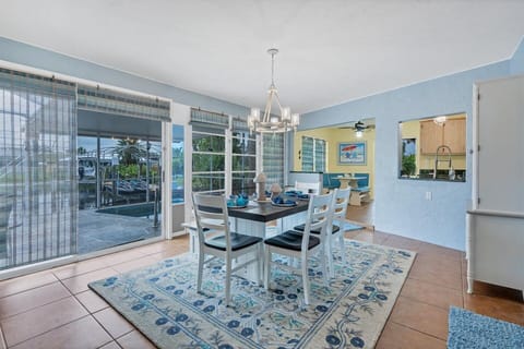 Bright and open dining room overlooks the canal and lanai
