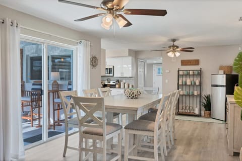 Dining room with additional refrigerator and lanai aceess. Dining table seats 8