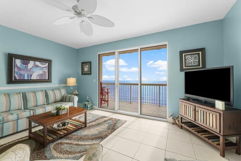 Relax in this coastal living room with ocean views through sliding glass doors.