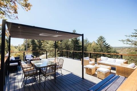 Take in sweeping forest views from the spacious rooftop deck with outdoor dining and lounge seating