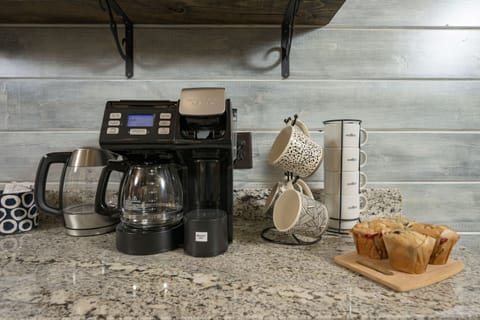 Cozy coffee station with fresh muffins and charming mugs—perfect morning start.