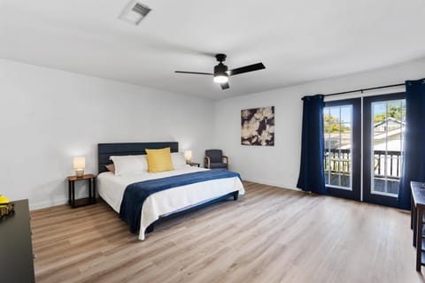 Large primary suite with French doors and balcony