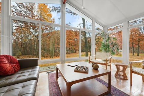Glass living room perfect for morning coffee or relaxing with a book. 