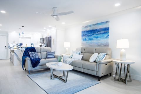 Bright and airy living room with coastal decor, plush seating, and a welcoming atmosphere.