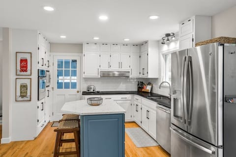 The kitchen features seating for two at the bar top.