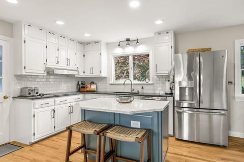 The kitchen features seating for two at the bar top.