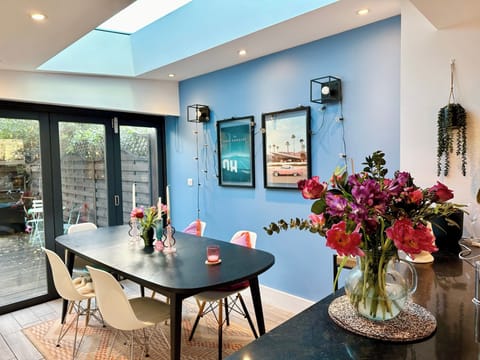 Dining area for 8 guests, under electric skylight, looking onto south facing garden.