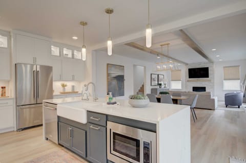 Kitchen: Crisp white cabinetry and modern pendant lighting add to the room's inviting atmosphere. This space is truly the heart of the home, designed for comfort and enjoyment.