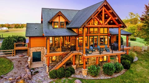 Experience the charm of this luxurious log cabin with stunning architecture, spacious balconies, and breathtaking views of the surrounding nature.