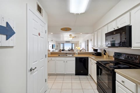 Open kitchen with modern amenities, connected to the dining and living areas.