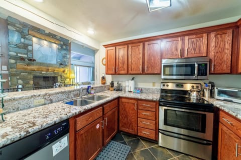 Kitchen overlooks living and dining area. Has electric stove/oven.