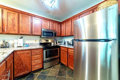 Updated kitchen with stainless steel appliances and solid stone countertops.