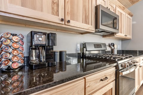 Kitchen equipped with coffee, tea, and coffee pods.  We have basic salt, pepper and olive oil as well.  All utensils, plates, bowls, glassware, crockpot and much more.